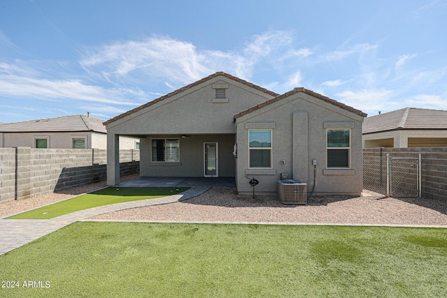 back of house with a patio area, a fenced backyard, a lawn, and stucco siding