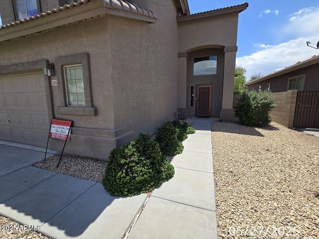 43455 W Chisholm Dr, Maricopa, AZ 85138 - doorway to property featuring stucco siding, a tile roof, and a garage