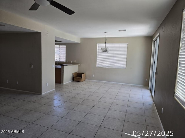 43455 W Chisholm Dr, Maricopa, AZ 85138 - unfurnished living room featuring ceiling fan, tile patterned floors, a chandelier, and baseboards
