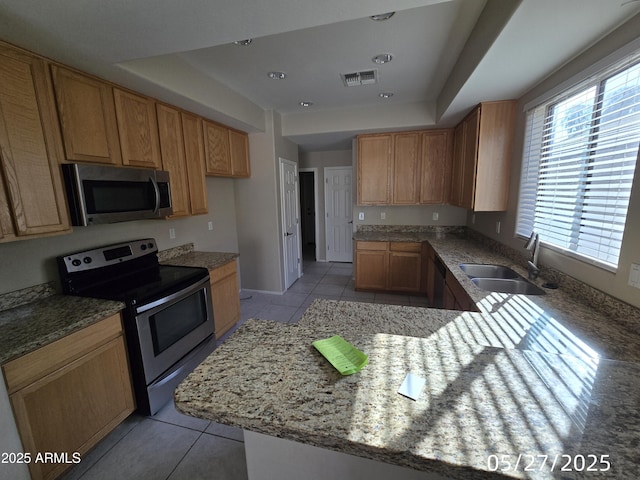 43455 W Chisholm Dr, Maricopa, AZ 85138 - kitchen featuring appliances with stainless steel finishes, a sink, light tile patterned flooring, and a peninsula