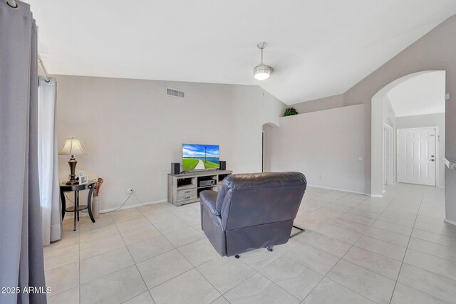 living room featuring vaulted ceiling and light tile patterned flooring