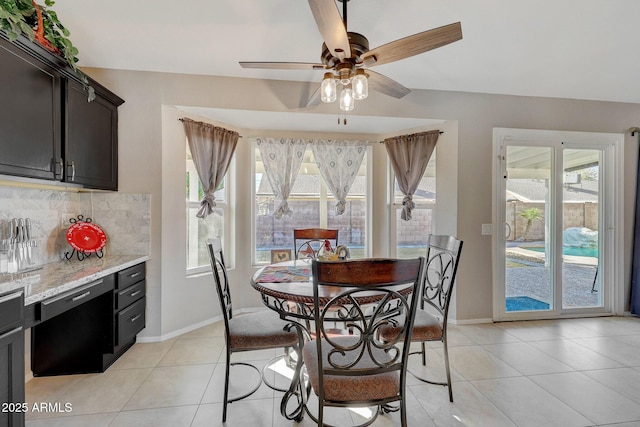 tiled dining space with ceiling fan