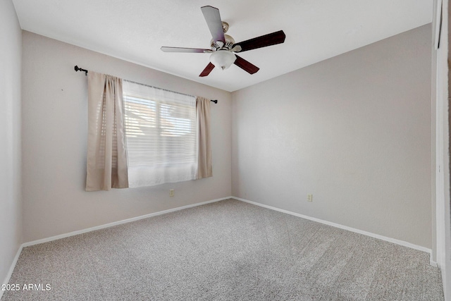 carpeted empty room featuring ceiling fan