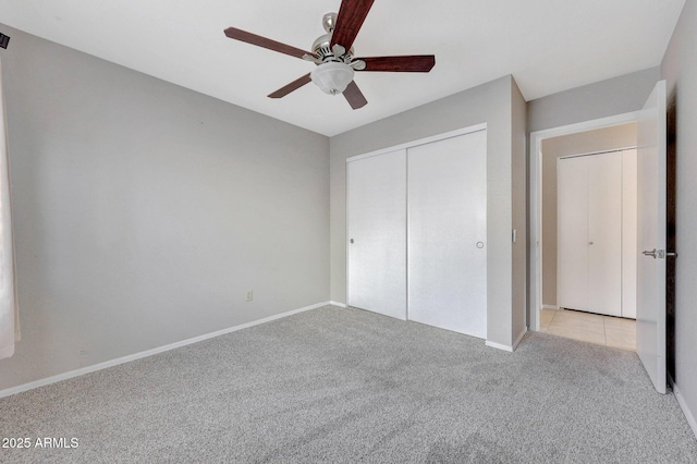 unfurnished bedroom featuring light colored carpet, ceiling fan, and a closet