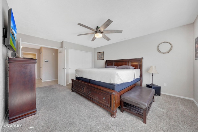 bedroom featuring light colored carpet, a closet, and ceiling fan