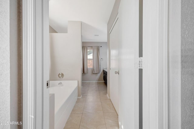 bathroom featuring vanity, a bathtub, and tile patterned floors