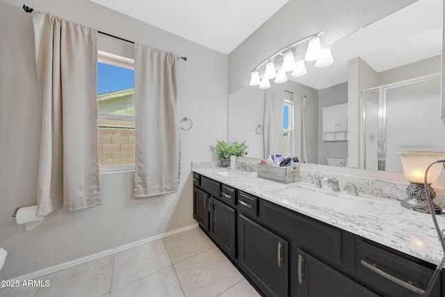 bathroom featuring vanity, a shower with door, tile patterned floors, and toilet