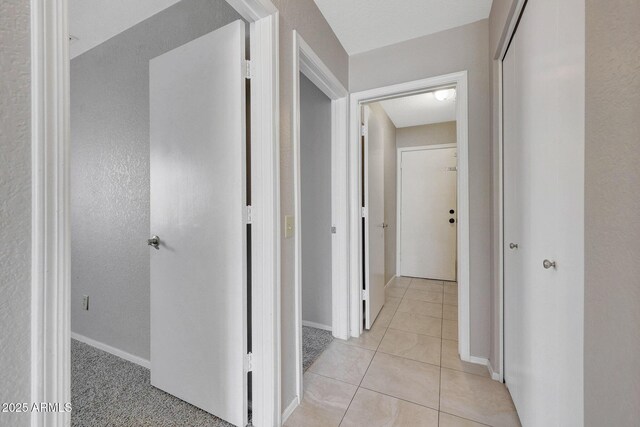 corridor featuring light tile patterned floors