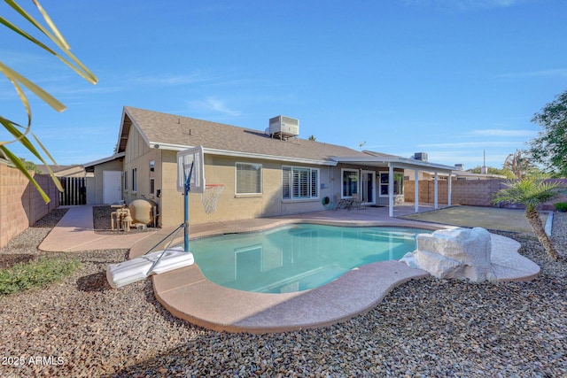 view of swimming pool with a patio and central air condition unit