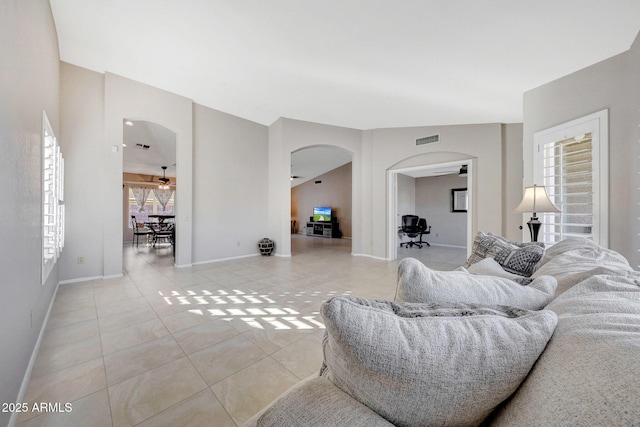 tiled living room with ceiling fan