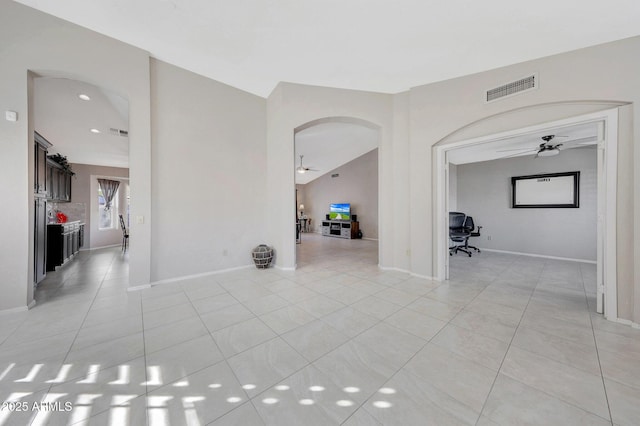 empty room with light tile patterned floors and ceiling fan