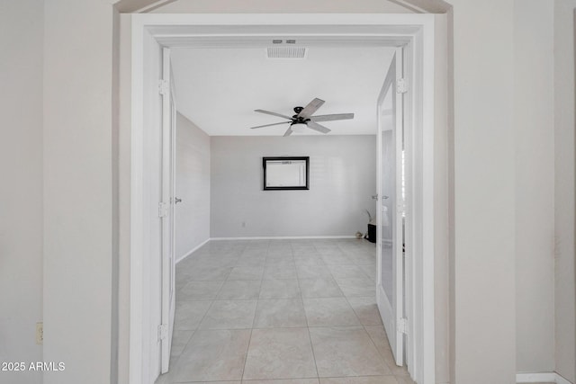 interior space with ceiling fan