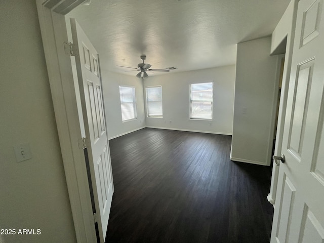 30944 N Bramwell Ave, San Tan Valley, AZ 85143 - unfurnished room featuring baseboards, a ceiling fan, dark wood-type flooring, and visible vents