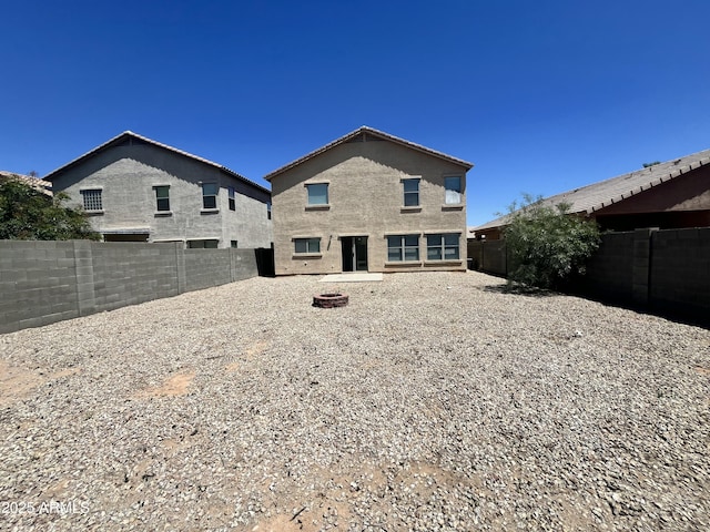 30944 N Bramwell Ave, San Tan Valley, AZ 85143 - back of house with a fenced backyard and a fire pit