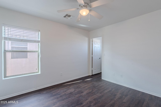 30944 N Bramwell Ave, San Tan Valley, AZ 85143 - spare room featuring visible vents, baseboards, ceiling fan, and dark wood-style floors