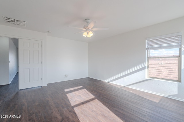 30944 N Bramwell Ave, San Tan Valley, AZ 85143 - spare room with ceiling fan, baseboards, visible vents, and dark wood finished floors