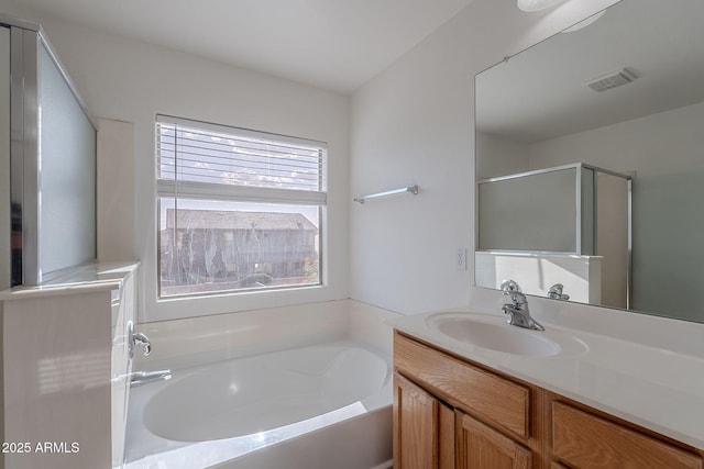 30944 N Bramwell Ave, San Tan Valley, AZ 85143 - full bathroom featuring visible vents, a shower stall, a garden tub, and vanity