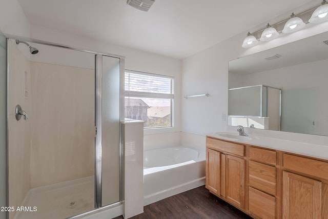 30944 N Bramwell Ave, San Tan Valley, AZ 85143 - full bath with vanity, a stall shower, wood finished floors, and visible vents