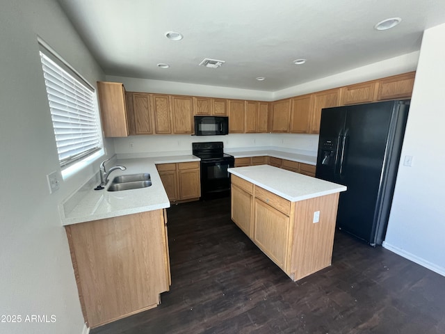 30944 N Bramwell Ave, San Tan Valley, AZ 85143 - kitchen with visible vents, a center island, light countertops, a sink, and black appliances