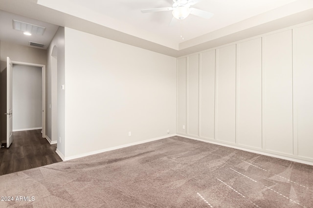 empty room featuring dark colored carpet and ceiling fan