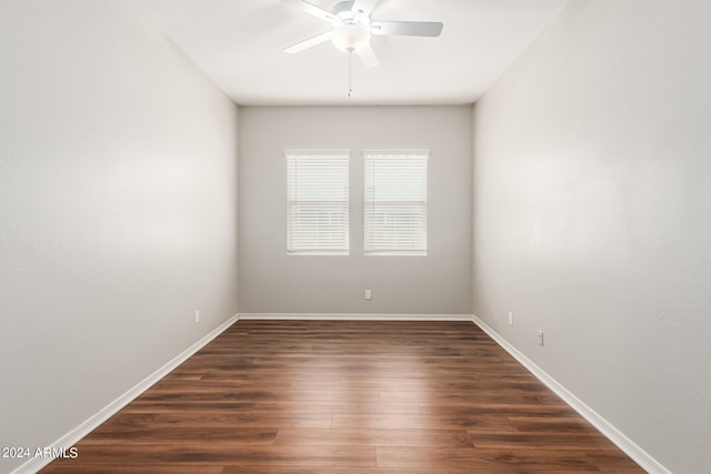 spare room with ceiling fan and dark wood-type flooring