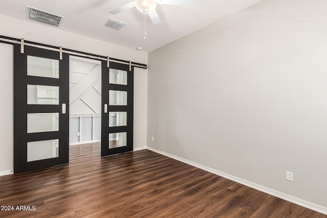 entrance foyer featuring ceiling fan, dark hardwood / wood-style floors, french doors, and a barn door