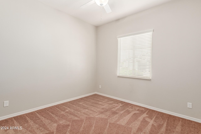 spare room featuring carpet and ceiling fan