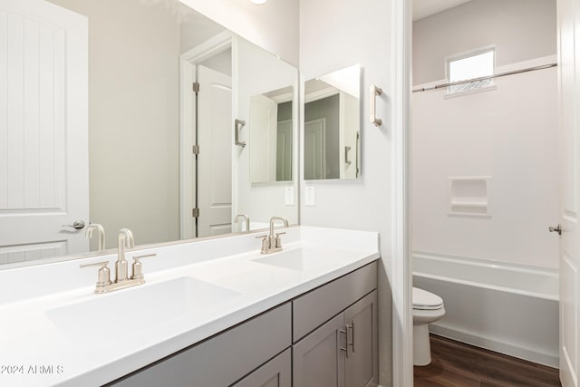 full bathroom featuring vanity, toilet,  shower combination, and hardwood / wood-style flooring