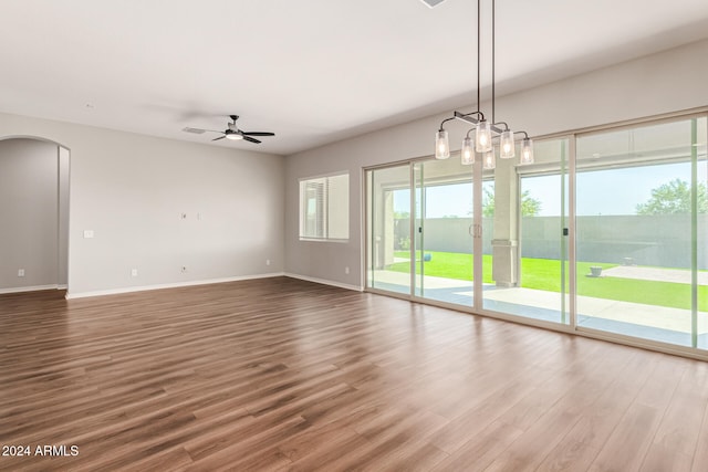 unfurnished living room with wood-type flooring and ceiling fan