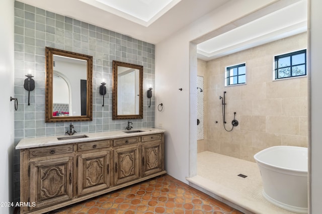 bathroom featuring tile patterned flooring, vanity, shower with separate bathtub, backsplash, and tile walls