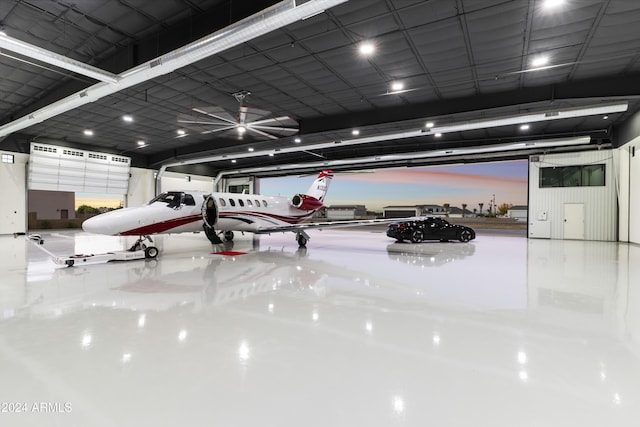 garage at dusk with ceiling fan