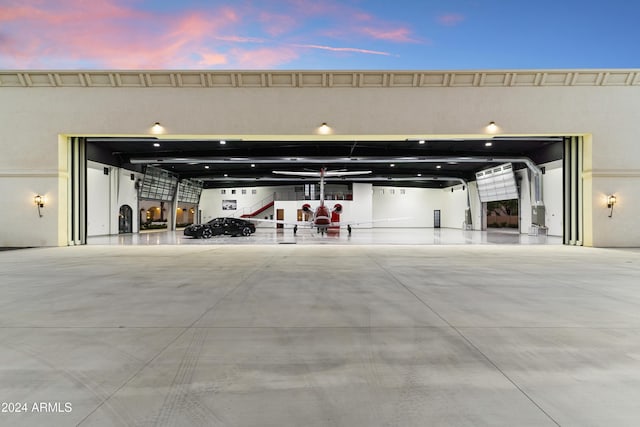 view of garage at dusk