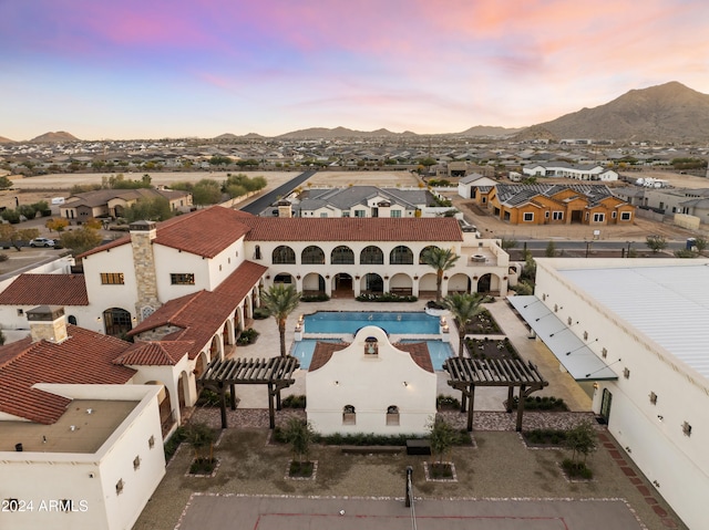 aerial view at dusk featuring a mountain view