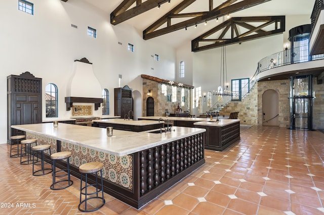 kitchen with beamed ceiling and a towering ceiling