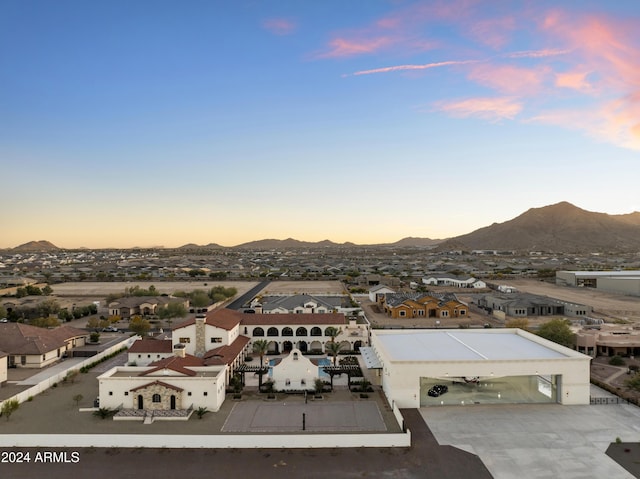 aerial view at dusk featuring a mountain view