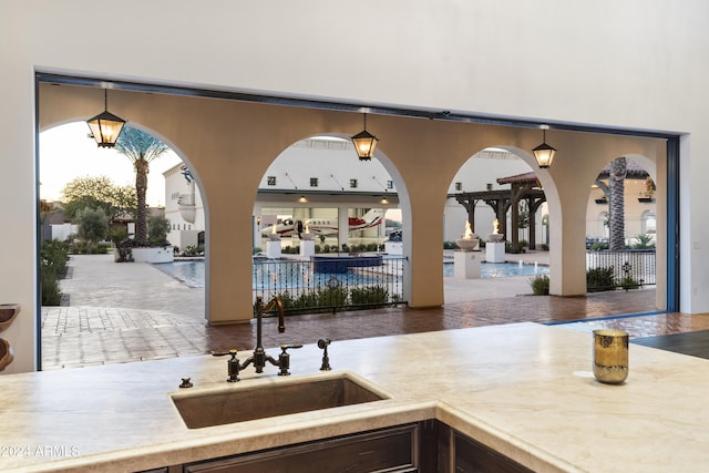 interior space with sink and hanging light fixtures