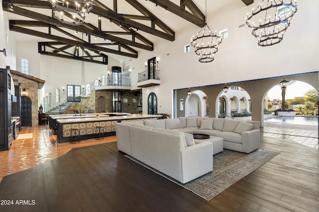 living room featuring beamed ceiling, hardwood / wood-style flooring, and high vaulted ceiling