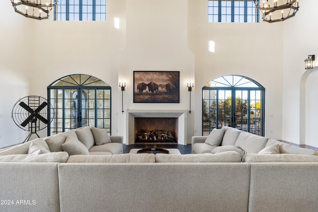 living room featuring french doors and a towering ceiling