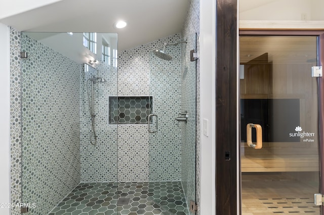 bathroom featuring tile patterned flooring and an enclosed shower