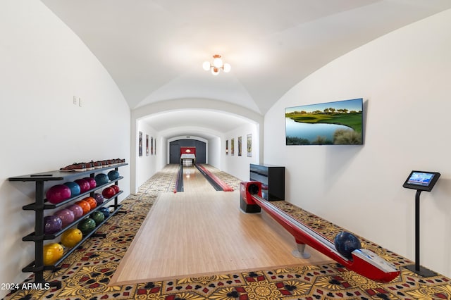 playroom with bowling, vaulted ceiling, and hardwood / wood-style flooring