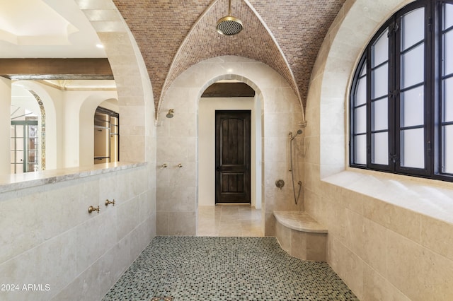 hall featuring tile walls