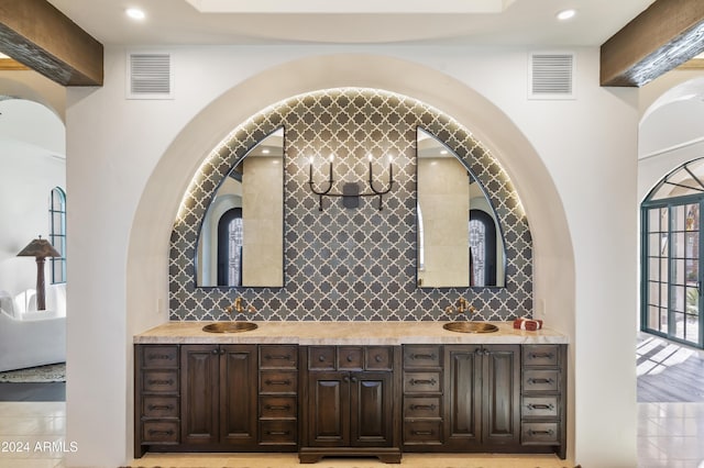 bathroom featuring backsplash and vanity