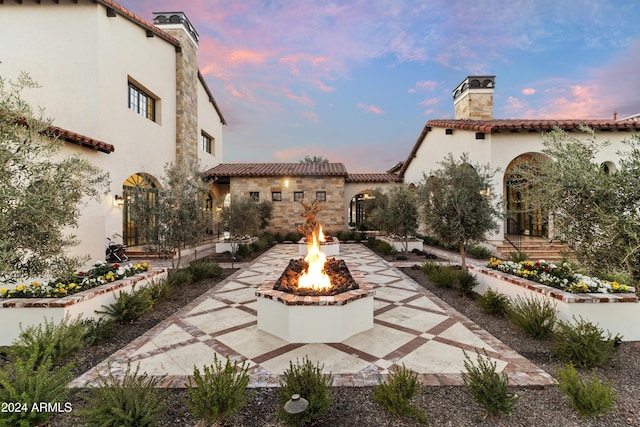 patio terrace at dusk with a fire pit