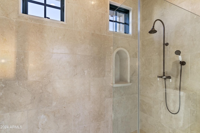 bathroom with a wealth of natural light and tiled shower