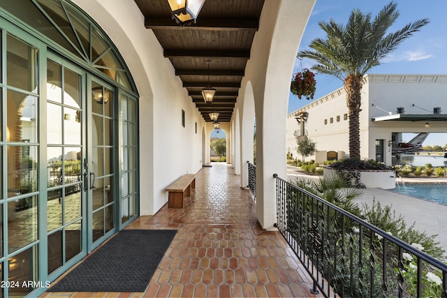 balcony with pool water feature and french doors