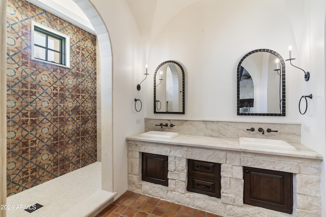 bathroom with a shower, vanity, and lofted ceiling