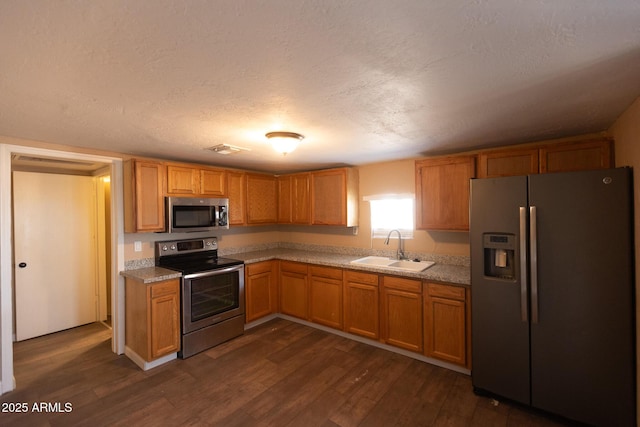 349 E Central Ave, Coolidge, AZ 85128 - kitchen with a sink, dark wood finished floors, a textured ceiling, and appliances with stainless steel finishes