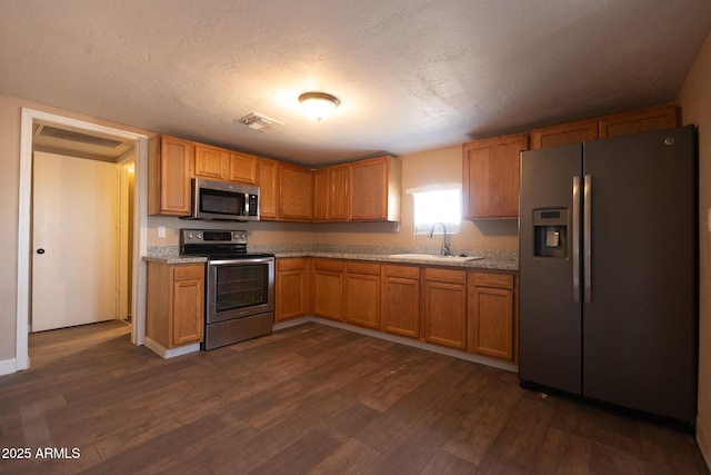 349 E Central Ave, Coolidge, AZ 85128 - kitchen with a sink, visible vents, dark wood-type flooring, light countertops, and appliances with stainless steel finishes