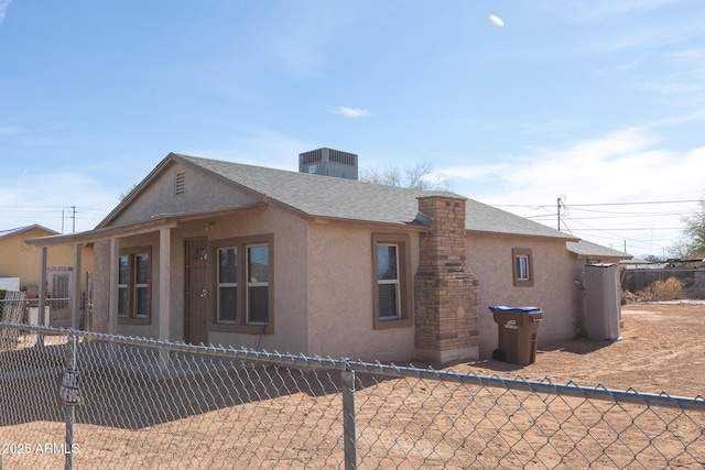 349 E Central Ave, Coolidge, AZ 85128 - view of side of home with a shingled roof, stucco siding, and fence