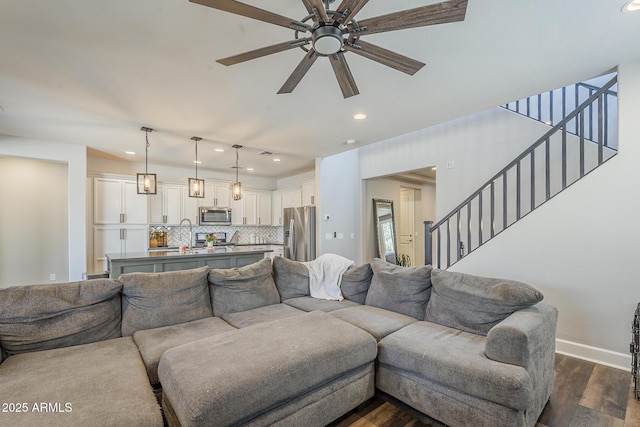 9752 E Torino Ave, Mesa, AZ 85212 - living room featuring dark wood finished floors, a ceiling fan, baseboards, stairs, and recessed lighting
